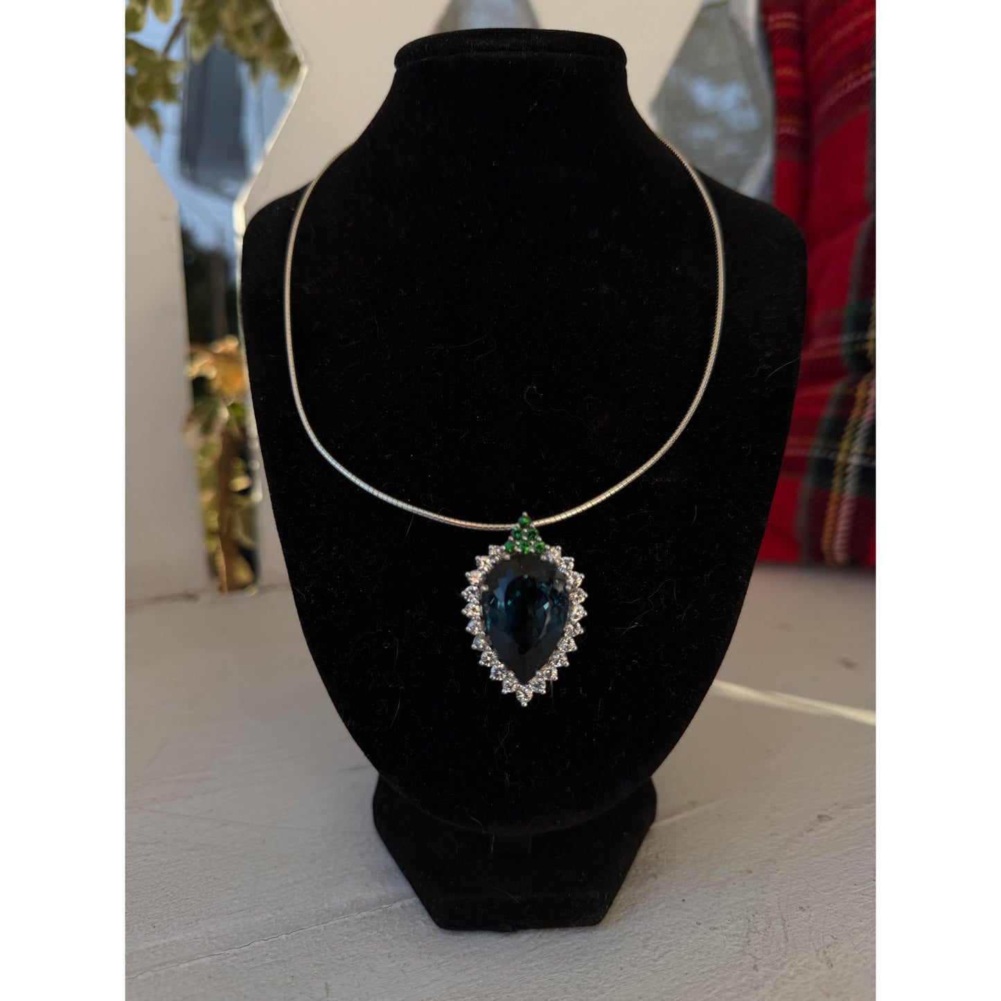 Pear-shaped London Blue Topaz with white sapphires and tsavorites