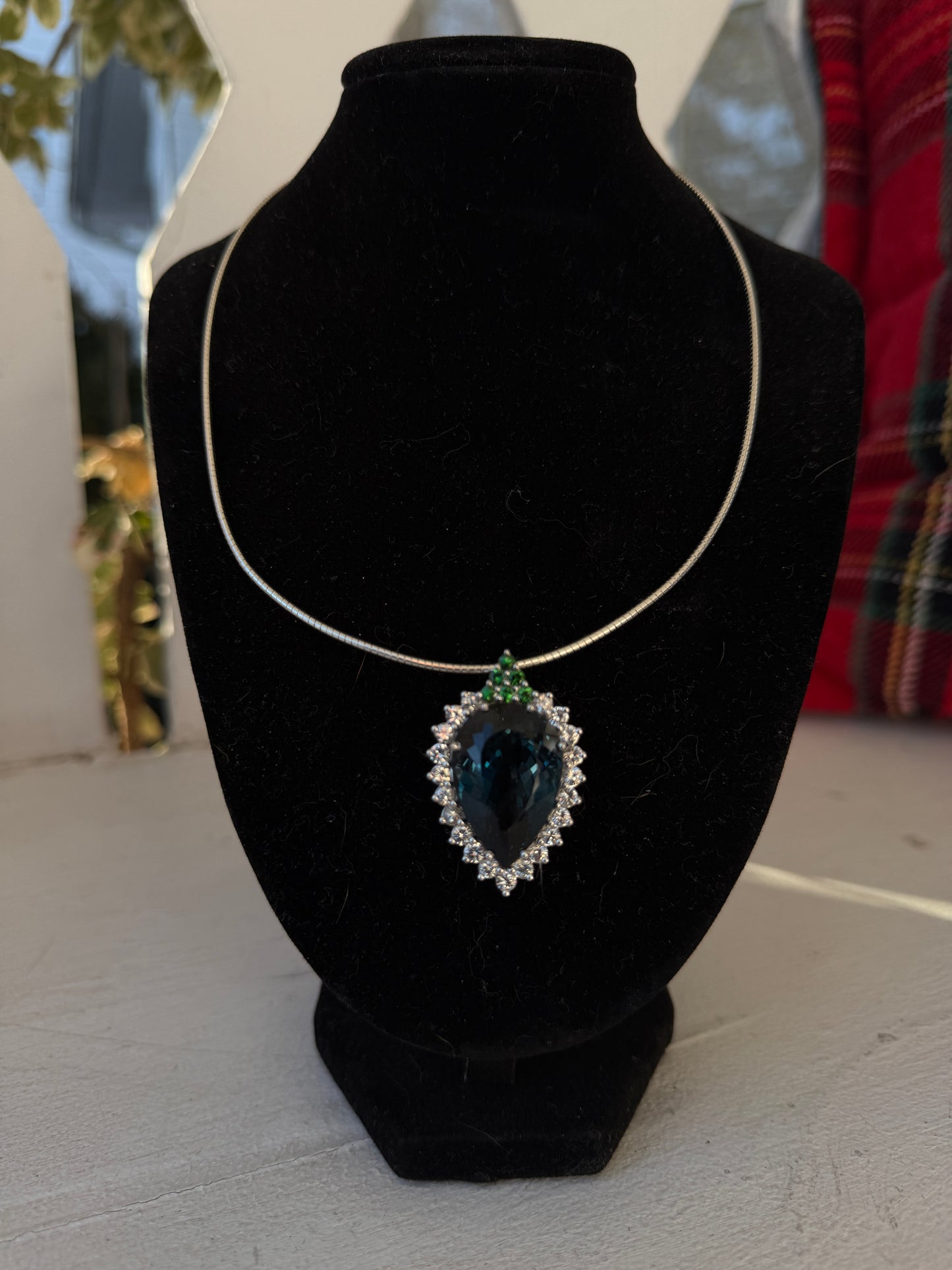 Pear-shaped London Blue Topaz with white sapphires and tsavorites