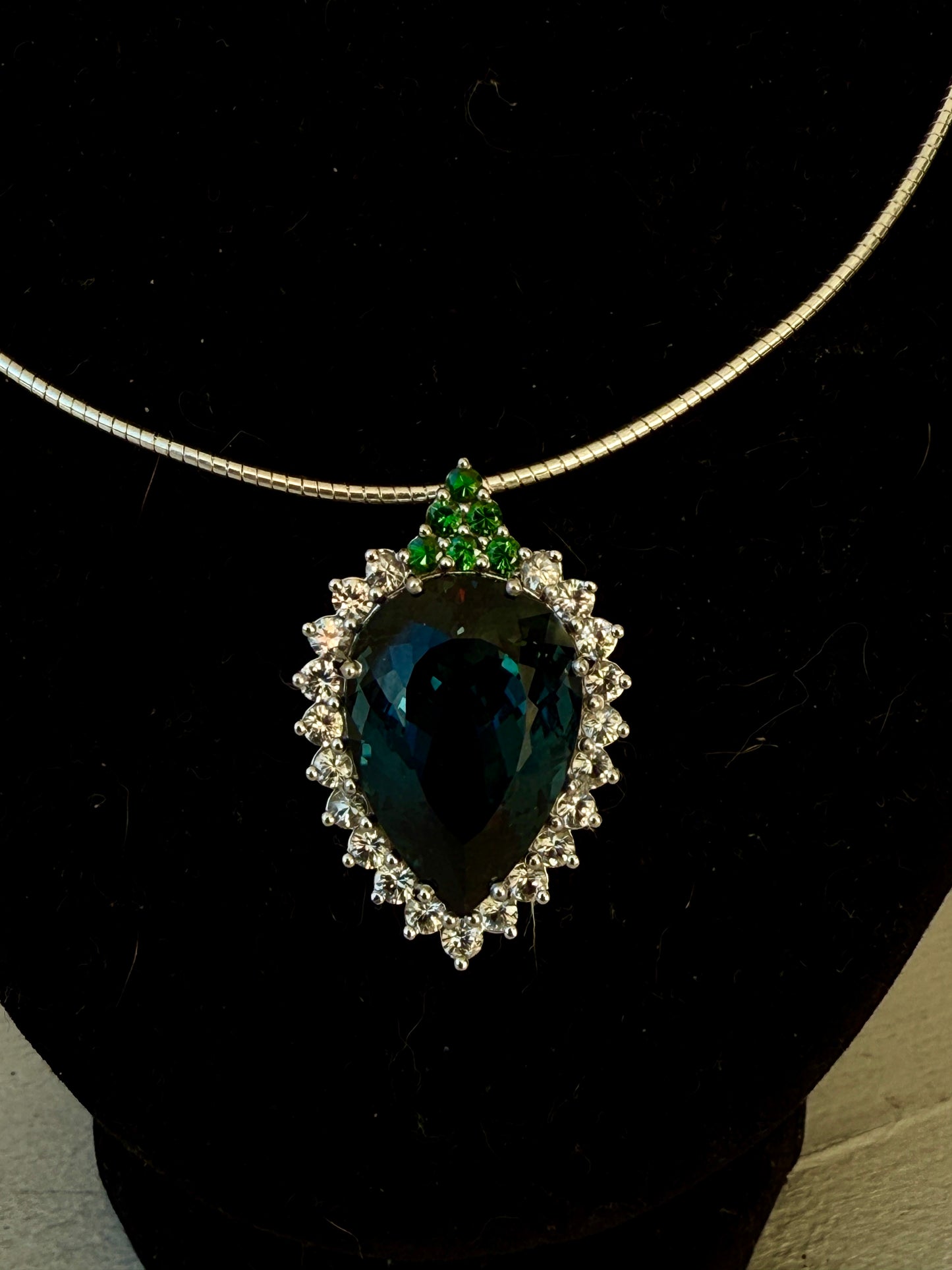 Pear-shaped London Blue Topaz with white sapphires and tsavorites