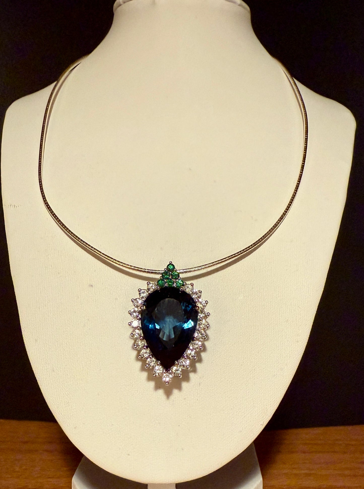 Pear-shaped London Blue Topaz with white sapphires and tsavorites