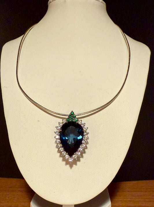 Pear-shaped London Blue Topaz with white sapphires and tsavorites
