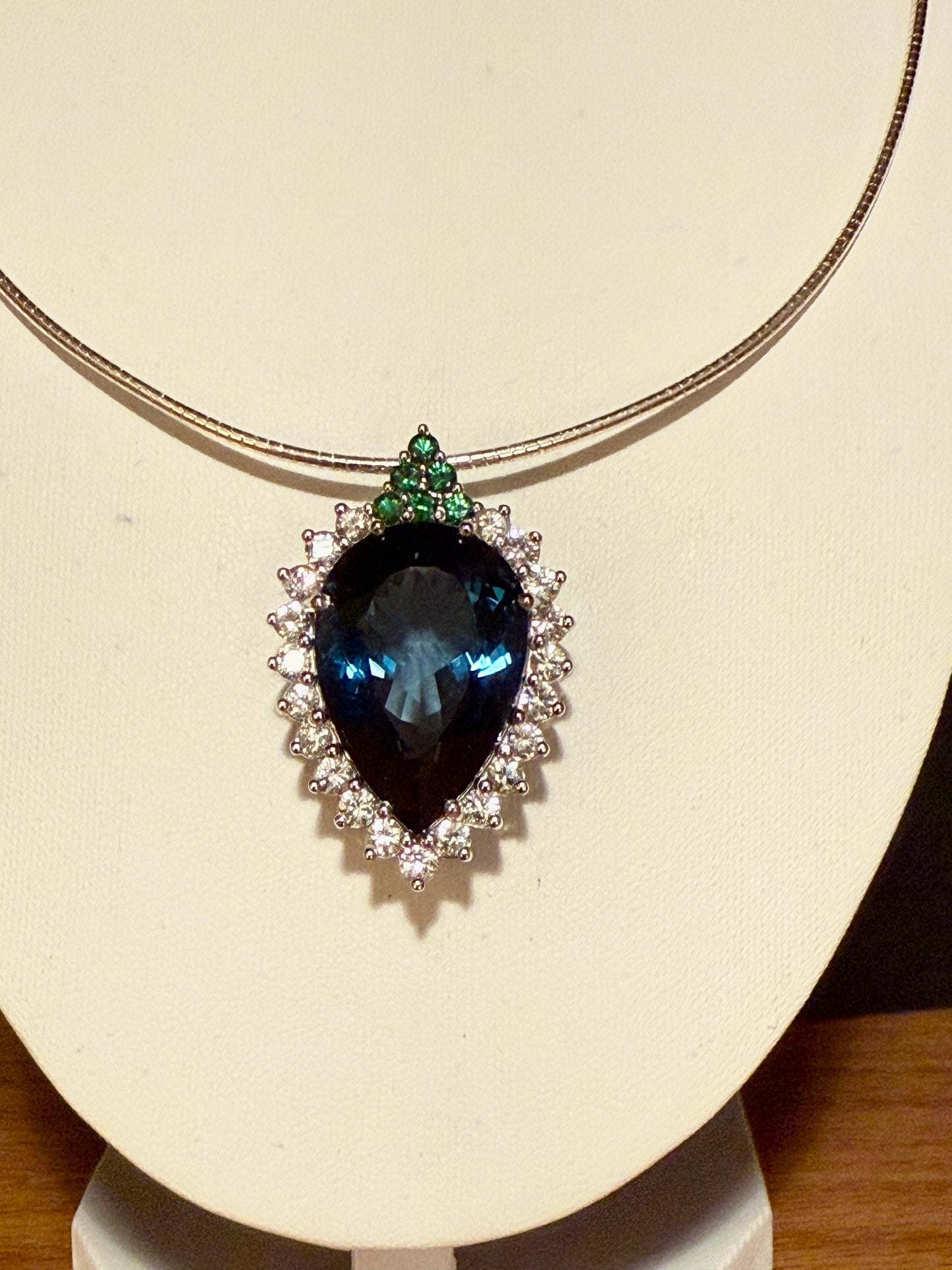 Pear-shaped London Blue Topaz with white sapphires and tsavorites