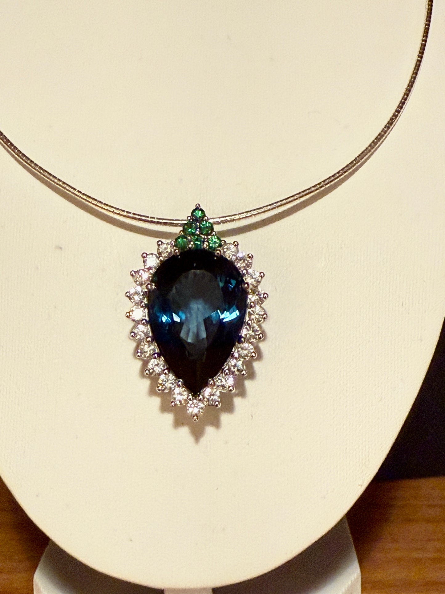 Pear-shaped London Blue Topaz with white sapphires and tsavorites